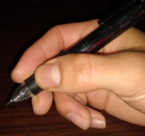 A photo showing one way to hold a pen.