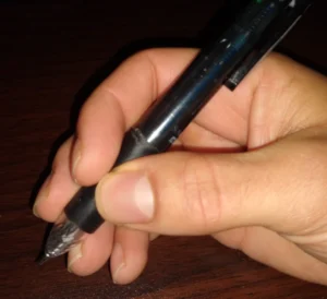 A photo showing another way to hold a pen.